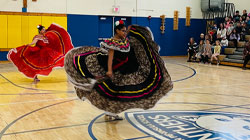 Grupo Folklorico Zochiquetzal performing in a gym.