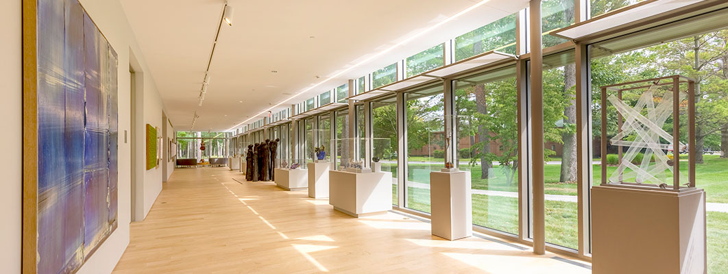 Photo of a hallway lined with sculptures at the Dennos Museum Center