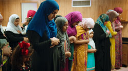 Women of the Victoria Islamic center pray in a temporary building after an arson destroys their mosque.