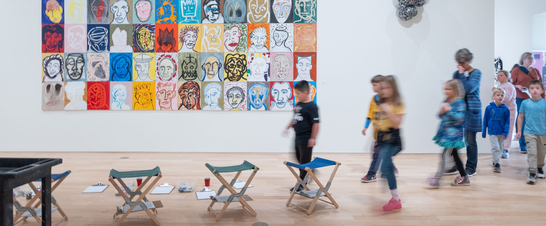 Photo of docent and young students at a Dennos event