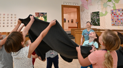 Image of kids playing together in the museum Sculpture Court.