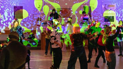 People dancing in the sculpture court at the Solstice Silent Disco December 2025. 