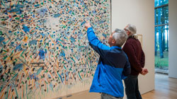 two men looking at an artwork in the museum's permanent collection.