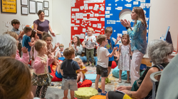 Kids enjoying a story time in the Discovery Gallery with TADL staff.